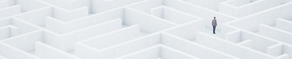 A person in a suit standing alone in a large, complex white maze representing a poor digital experience for b2b buyers.